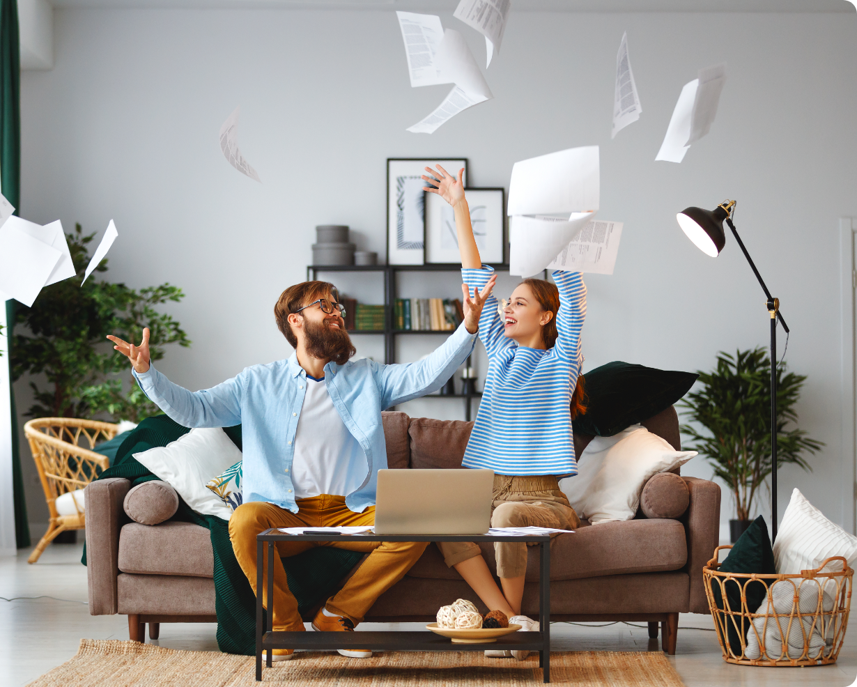 Young couple throwing papers in the air